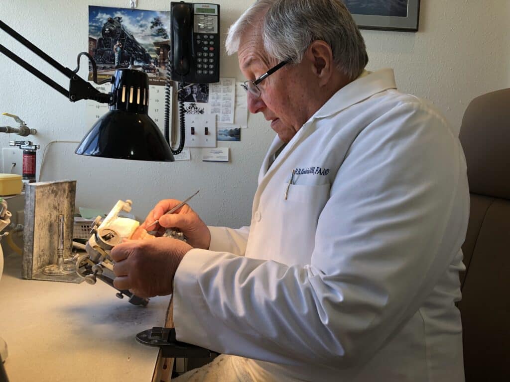 Brent Kandarian, the inventor of lower denture stabilizers working in his practice.